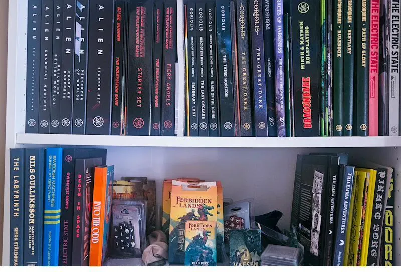 A shelf of Free League Publishing RPG books
